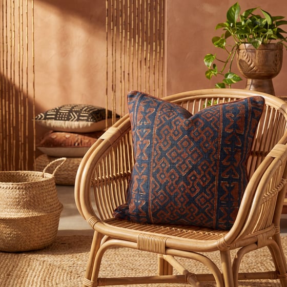 Adire-print woven throw pillow in an Afrohemian interior