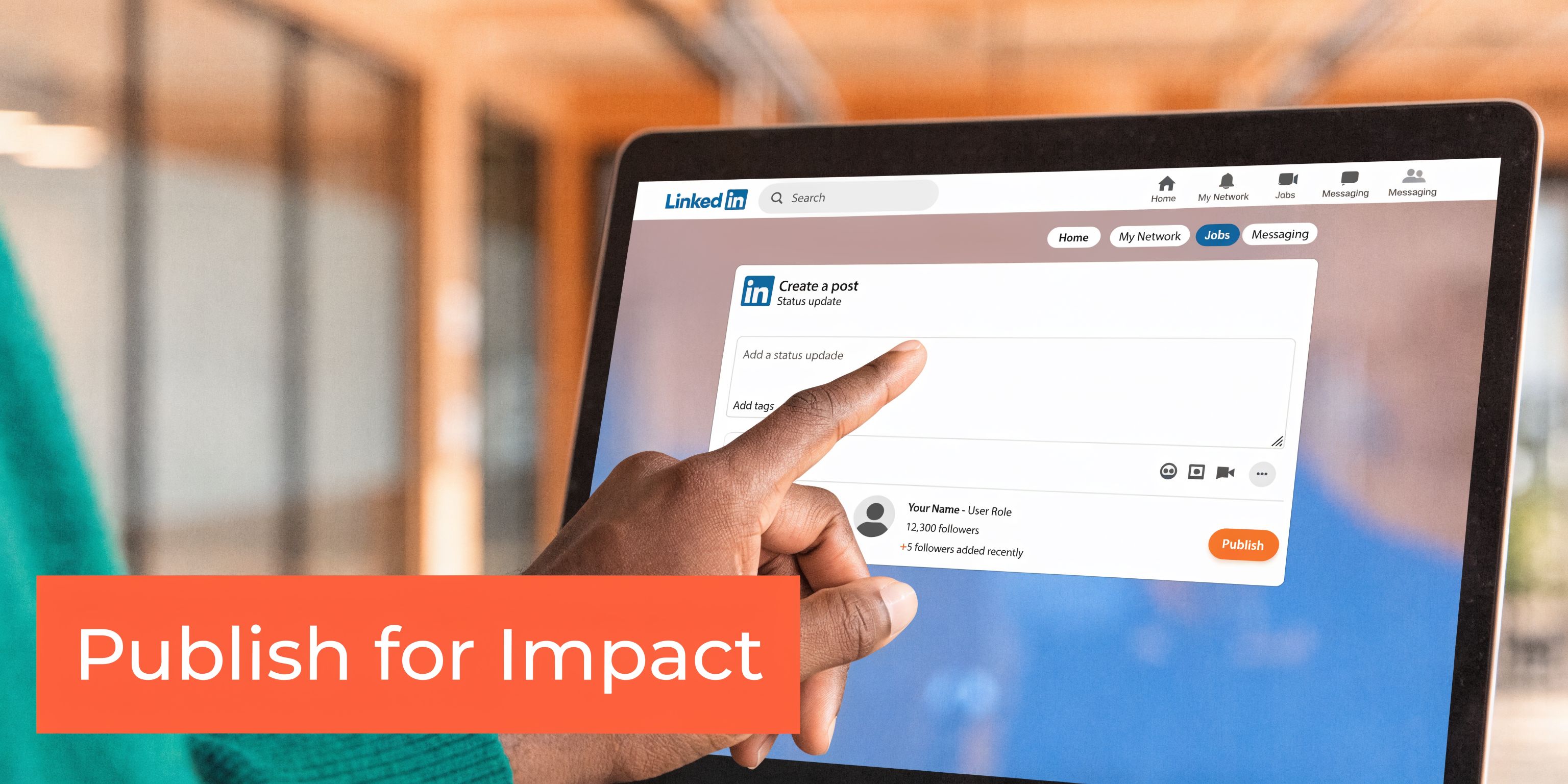 A close-up of a person's finger pointing to a screen displaying a LinkedIn post creation window.