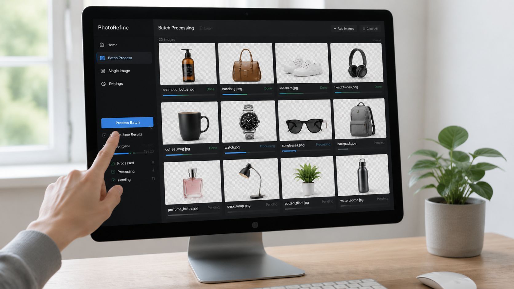 A hand pointing to a computer screen displaying an image editing software interface with multiple product photos.
